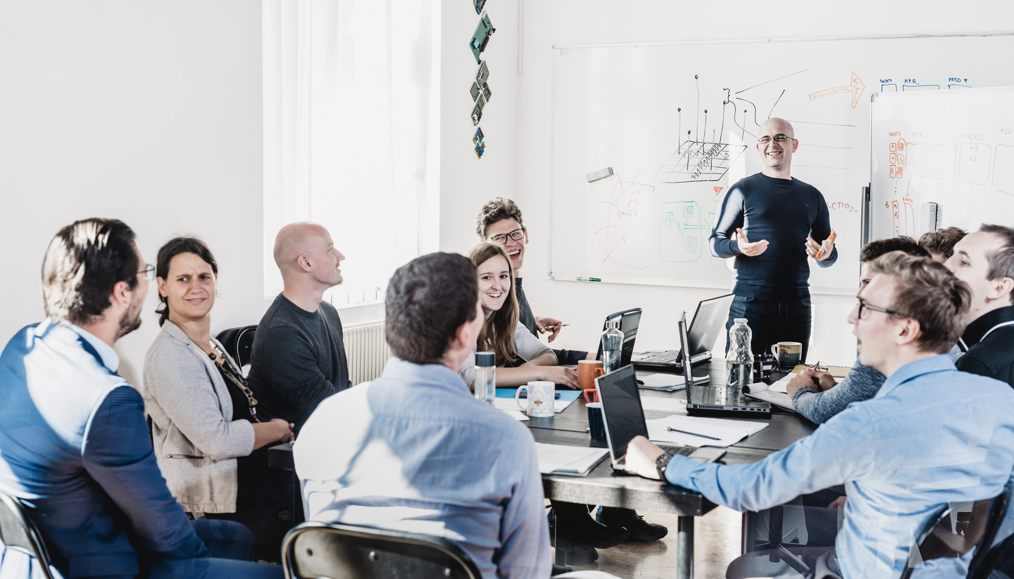 Relaxed informal IT business startup company meeting. Team leader discussing and brainstorming new approaches and ideas with colleagues. Startup business and entrepreneurship concept.