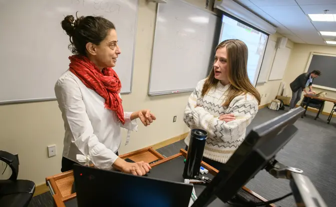 A student and a professor in a classroom