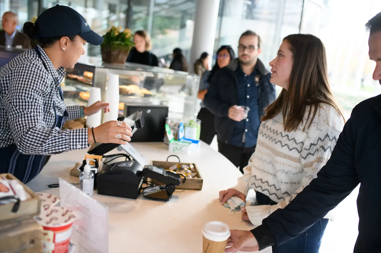 A student buying coffee in a café