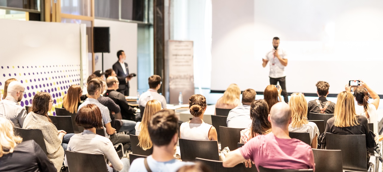 Man presents to a crowd