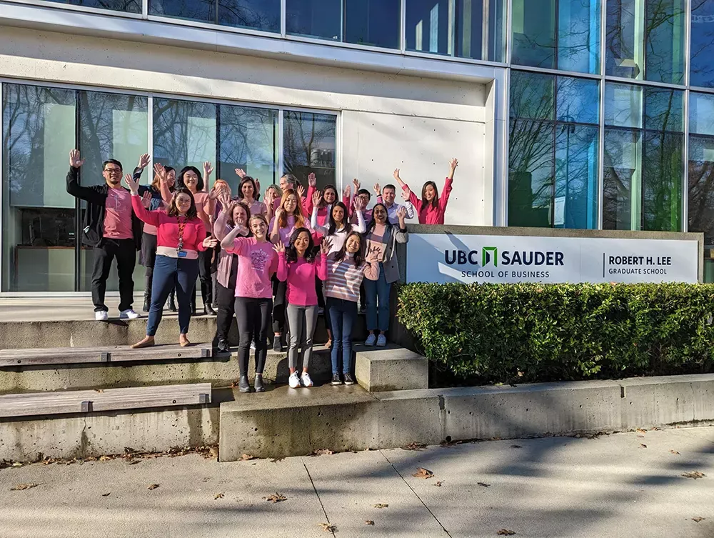 Pink Shirt Group Photo - Hands Up.webp 