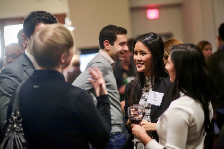 3 alum laughing over glasses of wine