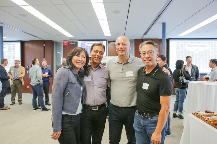 UBC Sauder alumni at a reunion posing for a photo inside the event space