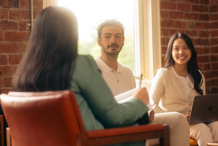 Students sit and listen to an advisor.
