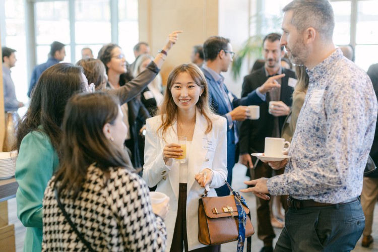 A group of UBC Sauder Alumni chatting at a breakfast gathering