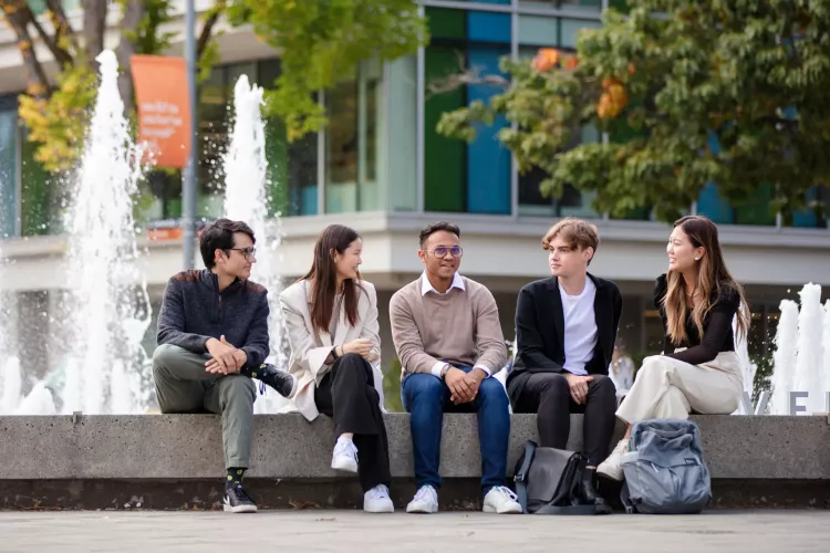 students gathered around fountain