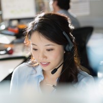 Image of woman with a headset talking