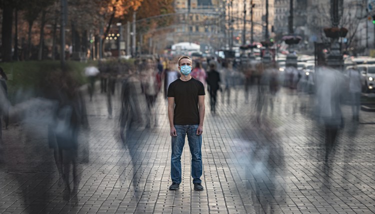 A man wearing a mask on the street.