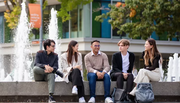 students gathered around fountain